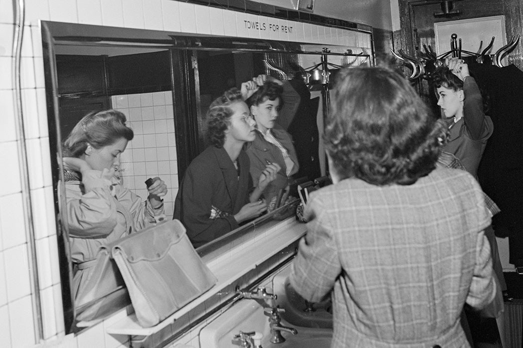 Passengers freshening up in the ladies' restroom at the Greyhound bus terminal, Chicago, 1943