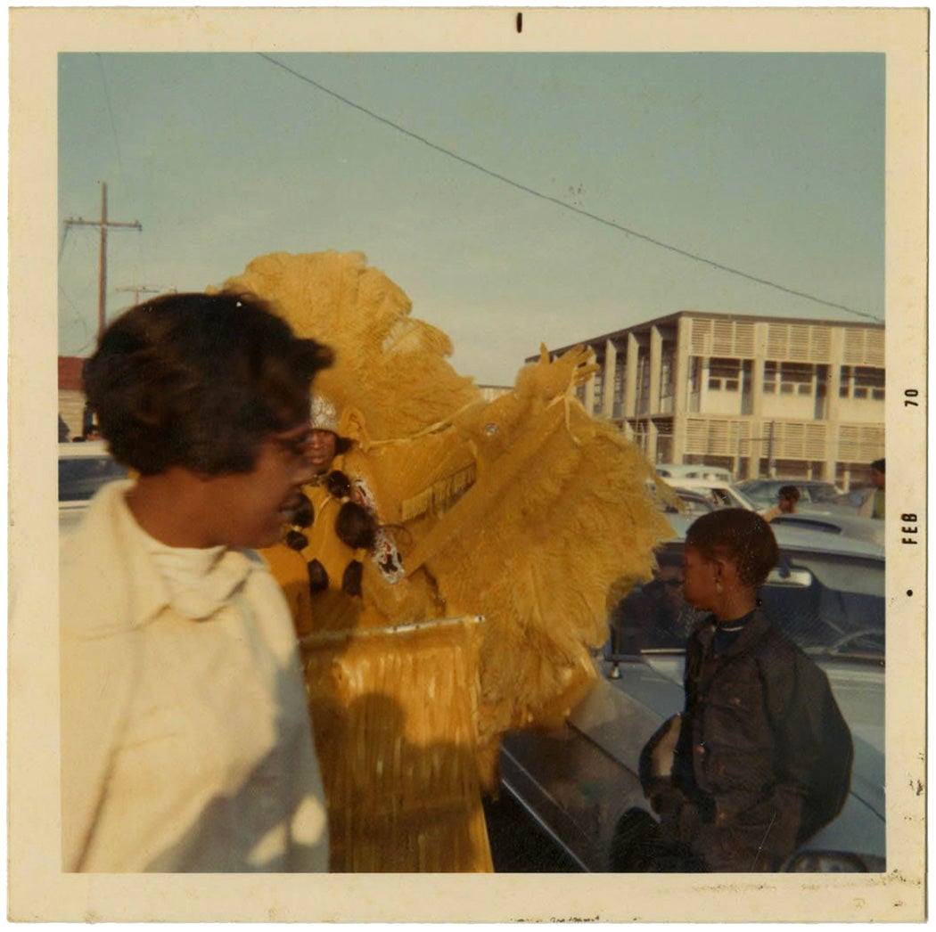 Photograph of a Mardi Gras Indian Posing with an Unidentified Woman and Boy