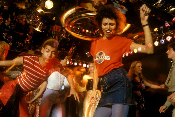 A general view of a 1970s disco showing people dancing, circa 1978.