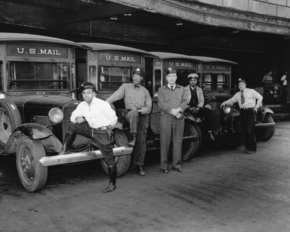 A group of United States Postal Service mechanics and vehicles, circa 1935