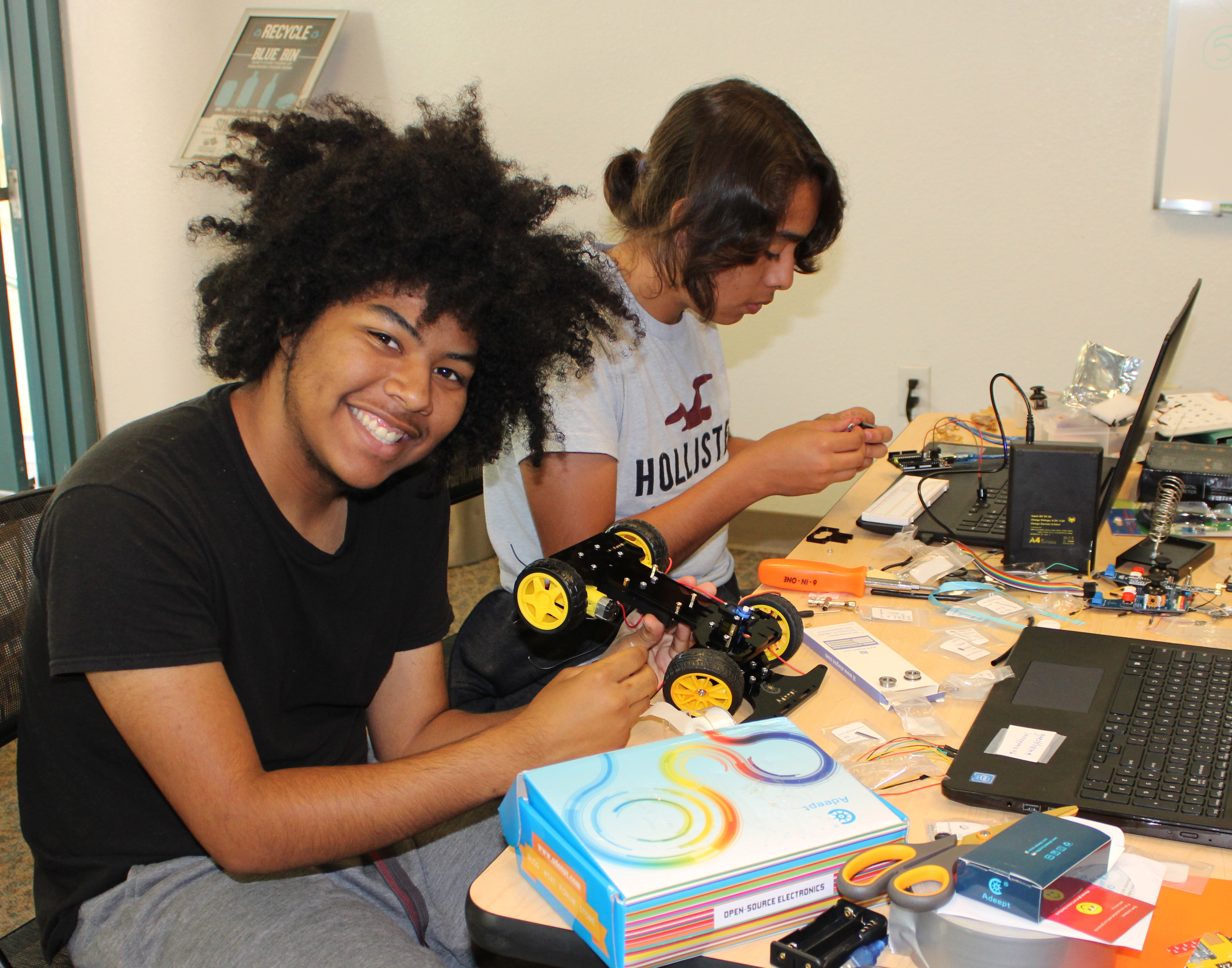 Teen boys and girls at the TryEngineering Summer Institute, a pre-college engineering summer camp for teens, showing their results from class and their college experience.