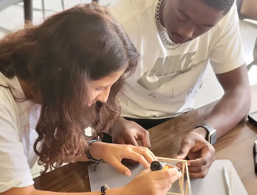 Two students working on a hands-on design challenge