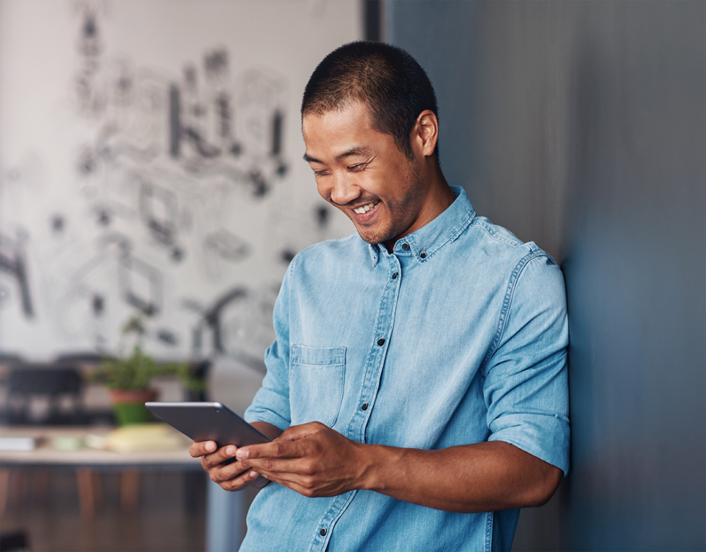 Man on tablet depicting a Young Professional at work