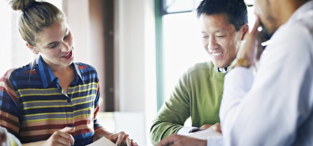 Coworkers discussing project in conference room