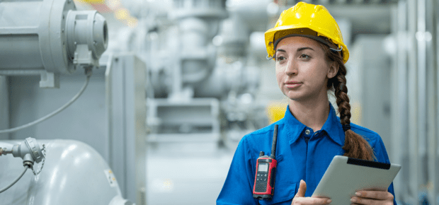 The HVAC ( Heating, Ventilation and Air Conditioning ) control systems. Female stationary engineer working at industrial mechanical room, examining the operation of the ventilation system in the factory.