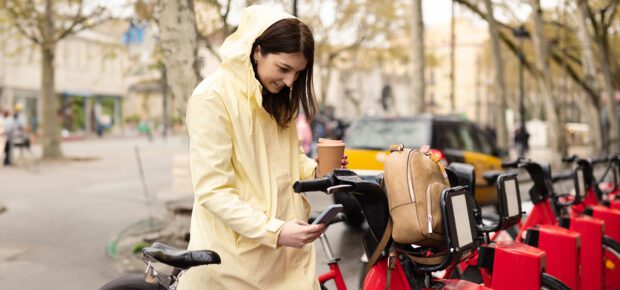 Young female tourist renting an e-bike to explore Barcelona