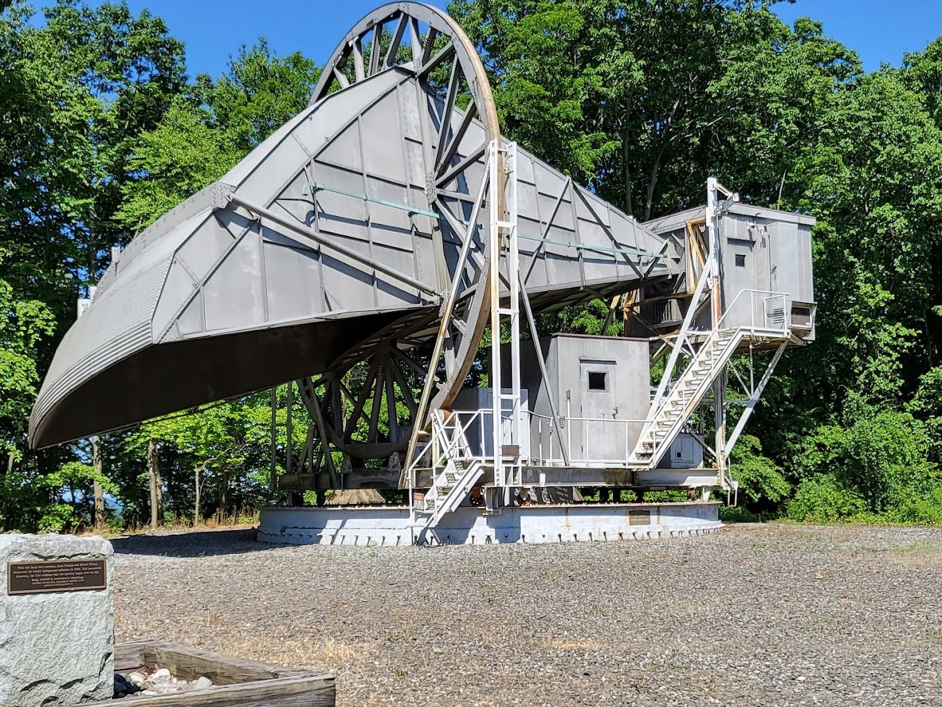 A large metal structure in a gravel areaDescription automatically generated