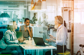 Three people in a corporate meeting