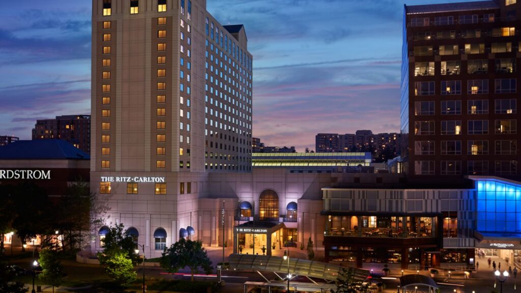 An evening photo of the Ritz Carlton at Pentagon City, next to Pentagon City Mall. It sits between Nordstrom and the mall entrance, and just past the Pentagon City metro entrance.