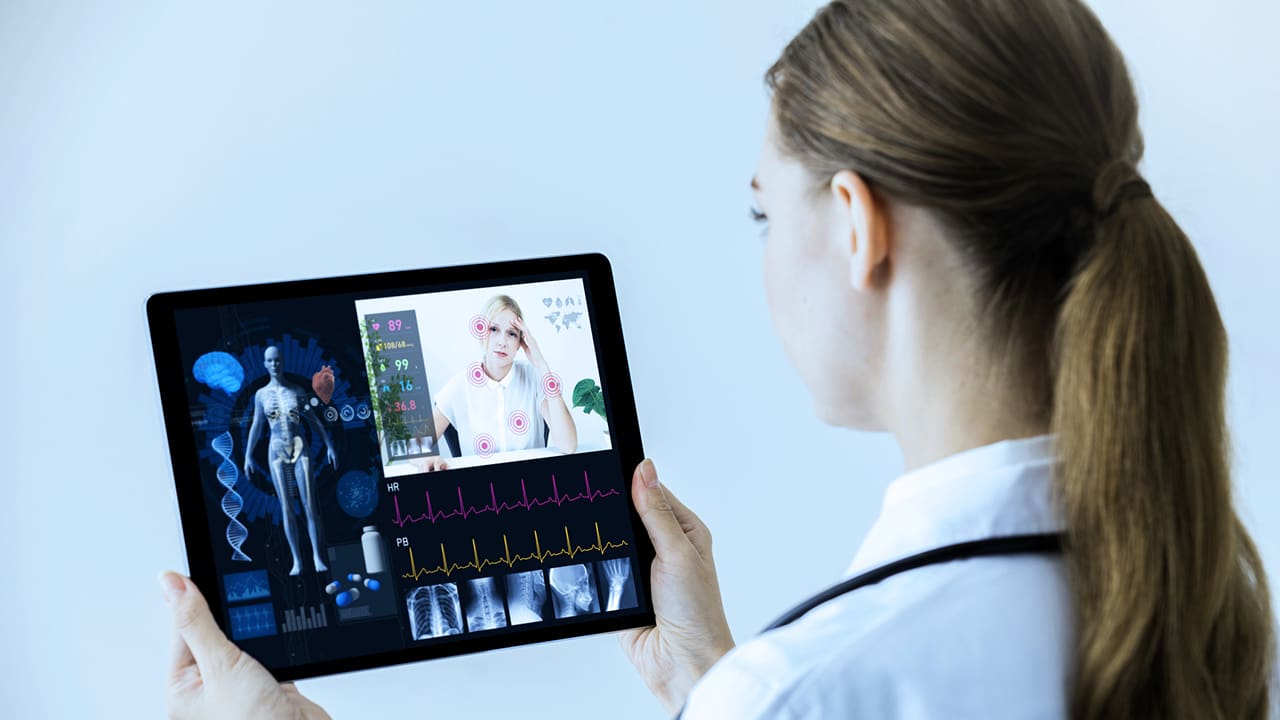 A stock image of a doctor holding a tablet displaying sample medical information.